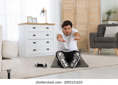 Overweight Man Stretching On Mat At Home, Space For Text