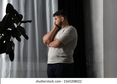 Overweight man suffering from depression at home