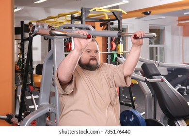 Overweight Man Training In Gym