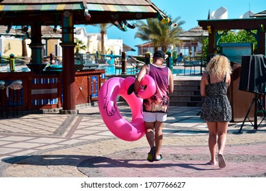 Overweight Man And Woman Go Swimming In A Hotel Pool.