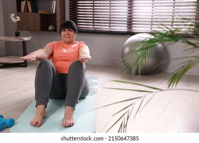 Overweight Mature Woman Doing Abs Exercise On Yoga Mat At Home, Space For Text