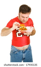 Overweight Middle Aged Man Eating Greasy, Fast Food Chicken Wings.  Isolated.