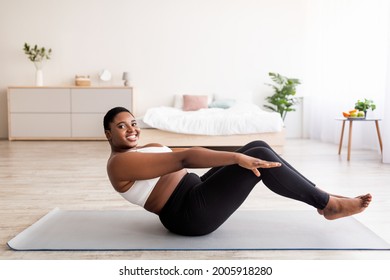 Overweight Millennial Black Lady Doing Abs Exercises, Training Core Muscles At Home, Copy Space. Plus Size Young Woman Working Out Indoors, Strengthening Her Body, Losing Weight