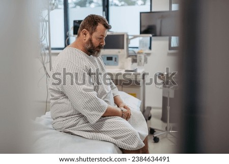 Overweight patient in hospital gown waiting for medical examination, test results in hospital, feeling anxious. Patient feeling dizzy, have vertigo and intense pain.