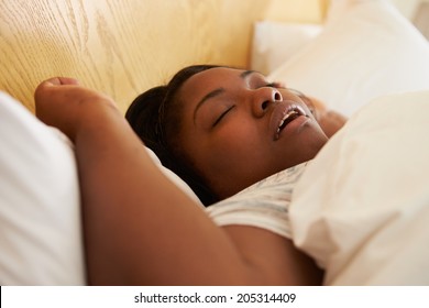 Overweight Woman Asleep In Bed Snoring