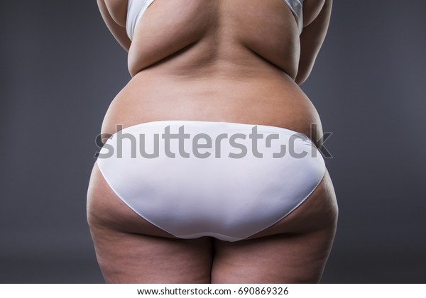 グレイの背景に太い脚と臀部 肥満した女性の体型 の写真素材 今すぐ編集