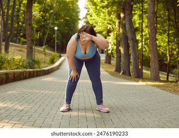 Overweight woman gets tired during intensive physical running workout in summer park. Breathless, exhausted, fat, sweaty, chubby lady in sportswear standing on stone pavement wiping sweat off forehead - Powered by Shutterstock