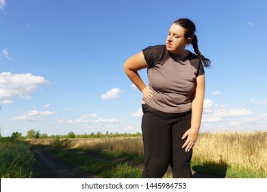 Overweight Woman Has Short Breath At Outdoor Jogging Workout. Fitness, Sports And Health Care