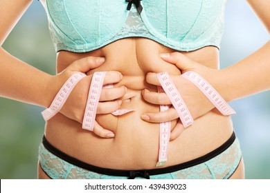 Overweight Woman Measuring Her Fat Belly