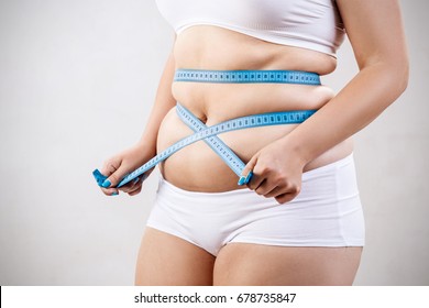 Overweight Woman Measuring Her Fat Belly.