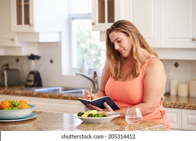 Overweight Woman On Diet Keeping Food Journal