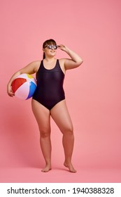 Overweight woman poses in swimsuit and sunglasses