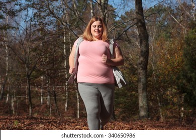 Overweight Woman Running In A Forest