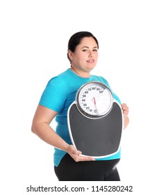 Overweight woman in sportswear with scales on white background