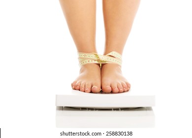 Overweight Woman Standing On A Scale