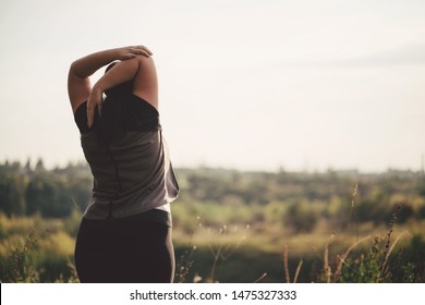 Overweight Woman Stretching Hands Relaxing While Walking Outdoors. Weight Loss And Active Lifestyle Concept