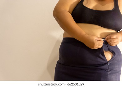 Overweight Woman Trying Fasten Her Skirt Stock Photo