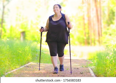Overweight woman walking on forest trail. Slimming and active lifestyle theme. 