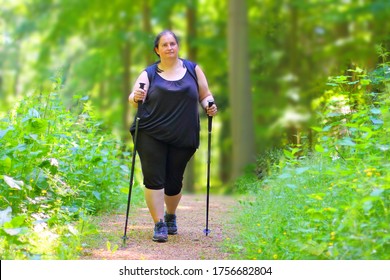 Overweight Woman Walking On Forest Trail. Slimming And Active Lifestyle Theme. 