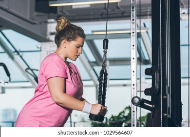 Overweight Woman Working Out On  Training Apparatus  