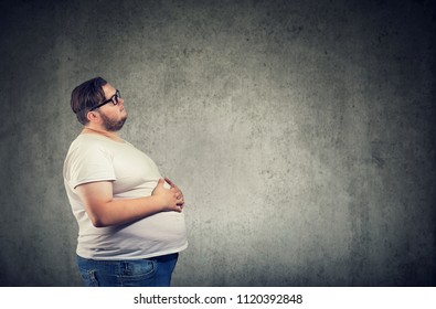Overweight young man with big belly 