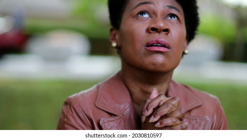 Overwhelmed African Woman Praying For Help. Suffering Black Girl Praying