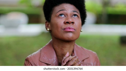 Overwhelmed African Woman Praying For Help. Suffering Black Girl Praying