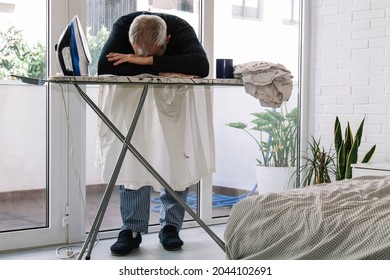 Overwhelmed Man Ironing. Concept Of Equality In Housework