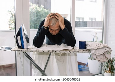 Overwhelmed Man Ironing. Concept Of Equality In Housework