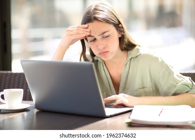 Overwhelmed Student E-learning Complaining Looking At Notes In A Coffee Shop