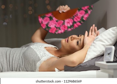 Overwhelmed Woman Faning Suffering Heat Stroke Lying In The Bed In The Night At Home