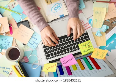 Overwhelmed woman working at messy office desk, top view - Shutterstock ID 1928432651