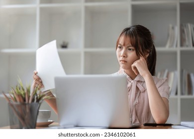 Overworked businesswoman at office looking at paper document holding hand on his head feeling hopeless trying to find solution for given problem working too hard need break for better concentration - Shutterstock ID 2346102061