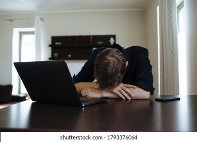 Overworked Freelancer In The Home Office, Worker At The Computer. Remote Video Team Meet Tired Man Frustrated Businessman Working Behind Laptop. Burnout As A Syndrome Linked To Chronic Work Stress