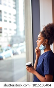 Overworked Nurse In Scrubs With Face Mask Takes Coffee Break In Busy Hospital During Health Pandemic