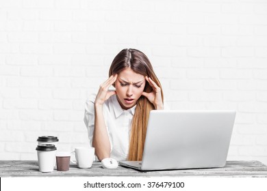 Overworked tired businesswoman. Young exhausted student girl working in office. Woman using laptop computer at home. Entrepreneur, business, freelance work, study, stress concept