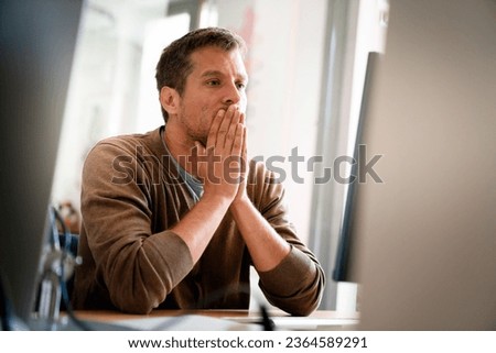 Overworked tired employee, programmer at workplace in office being unhappy