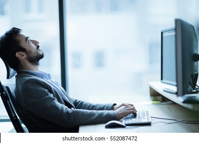 Overworked tired employee at workplace in office being unhappy - Shutterstock ID 552087472