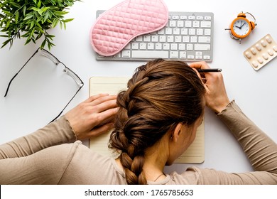 Overworked Woman Sleeps On White Office Desk Top View