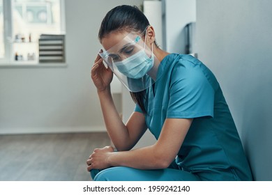 Overworked Young Female Nurse In Protective Workwear 