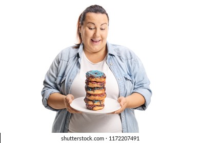 Oveweight female looking at a pile of doughnuts on a plate isolated on white background