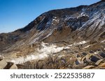 Owakudani Japan, the hot spring area of Owakudani in Hakone at daytime. The lunar landscape of mountains and rocks in the countryside of Japan on a bright clear day with blue sky in winter in Japan.