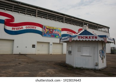 Owatonna, Minnesota, USA - September 6, 2020.  Grandstand At The Steele County Free Fair.  White Building With Ticket Booth And Colorful Painted Banner.  