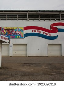 Owatonna, Minnesota, USA - September 6, 2020.  Grandstand At The Steele County Free Fair.  White Building With Ticket Booth And Colorful Painted Banner.  