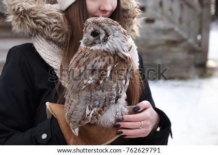 Owl perched on a young lady's arm at the Vitoslavlitsy Museum