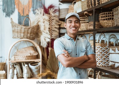 Owner a craft business with crossed hands while in a craft shop with handmade crafts on the shelf background