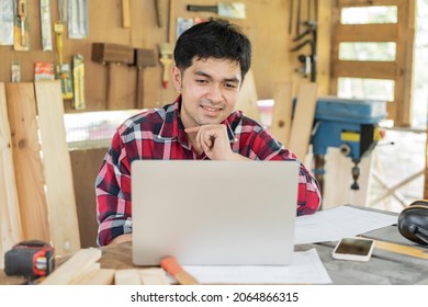 Owner Entrepreneur Startup Small Shop Business. Professional Of Carpenter Asian Young Man Handcraft Furniture Making In Hardwood, Use Laptop Computer For Marketing Online. Factory Industry Of Wood.