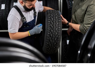 Owner Garage Shop Holding Best Tire In A Supermarket Mall, Measuring Rubber Car Wheel. At Work Place