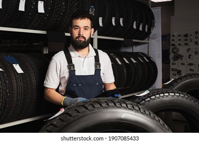 Owner Garage Shop Holding Best Tire In A Supermarket Mall, Measuring Rubber Car Wheel. At Work Place