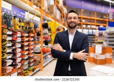 The Owner Of A Locksmith Tool Shop Is Pleased To Look At The Camera With His Arms Folded Across His Chest In A Business Suit